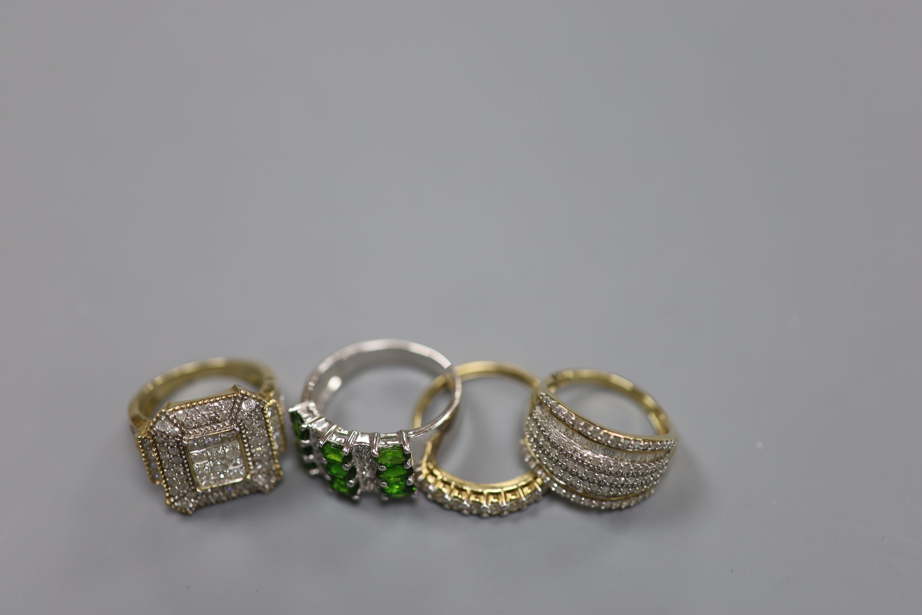 Two modern 9ct gold and pave set diamond dress rings, size N/O and a similar 9ct gold and nine stone diamond set half hoop ring, size R/S, gross 11.3 grams and one other 925 ring.